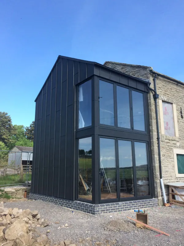 Dark clad extension with full-height anthracite glazing