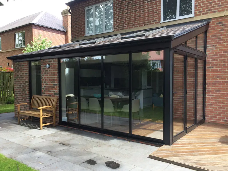 Anthracite glazed garden room with sliding doors on a brick house
